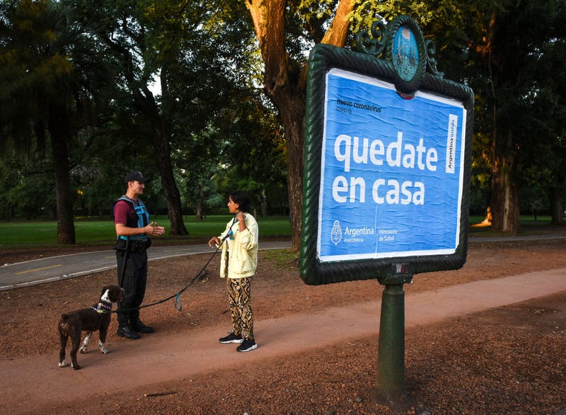 Police Officer explains to a person that they cannot go out to the streets during the first day of total quarantine on March 20, 2020 in Buenos Aires, Argentina. President Alberto Fernandez declared a national mandatory quarantine until March 31st to reduce the circulation of the COVID-19 outbreak. Only those who work in the health system, production and commercialization of food, press and other essential services are authorized to circulate.