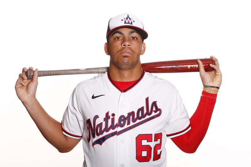 Nationals shortstop prospect Luis Garcia holds a bat during a team photo shoot