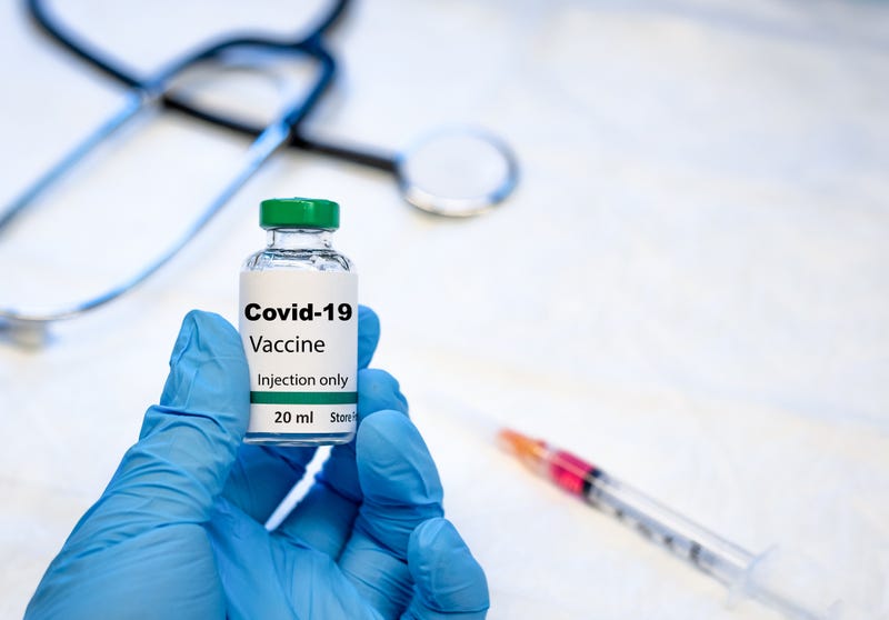 coronavirus vaccine vial with syringe and stethoscope