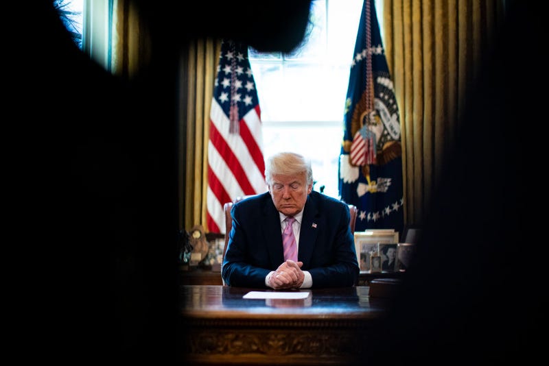 President Donald Trump bows his head during a Easter blessing by Bishop Harry Jackson, senior pastor at Hope Christian Church in Beltsville, Md., in the Oval Office of the White House on April 10, 2020 in Washington, DC.