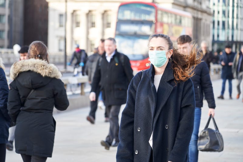 woman walking wearing a face mask