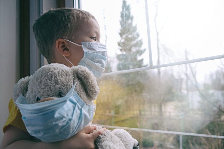 child wearing face mask with teddy bear