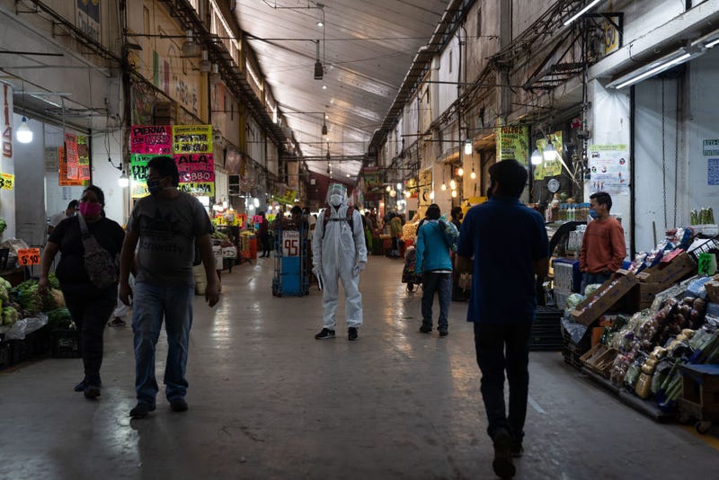 Health Department employee wearing safety equipment looks on at the Central de Abasto on May 8, 2020 in Mexico City, Mexico. The Central de Abasto is the largest market in Mexico and Latin America, boasting financial transaction volumes only surpassed by The Mexican Stock Exchange, where 90,000 employees work every day. Increased security measures have taken place in the market since it has become one of the strongest concentrations of COVID-19 transmissions in the city, where some workers have temporarily closed their businesses and overall commercial activities have been reduced on average 25%.