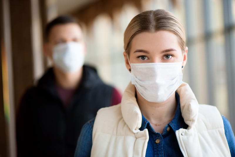 Man and woman wearing protective mask against transmissible infectious diseases