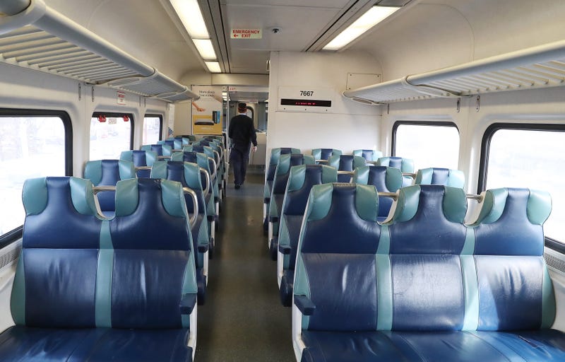 A train conductor walks through a near-empty car on the Long Island Railroad in March.