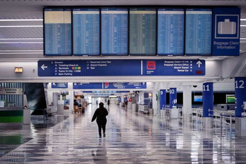 A worker walks through a baggage claim area at a nearly-empty O'Hare International Airport on April 2, 2020 in Chicago, Illinois. The airport, which typically serves 8.2 million passengers a month, has closed two of its seven runways as the COVID-19 pandemic has significantly reduced air travel. (Photo by Scott Olson/Getty Images)