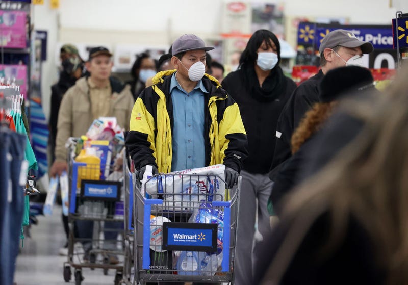 People wearing masks and gloves wait to checkout at Walmart on April 03, 2020 in Uniondale, New York