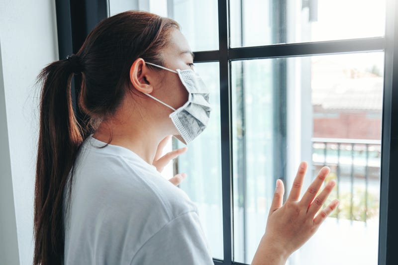 Asian woman in isolation at home for virus outbreak Coronavirus wearing a face mask quarantine herself
