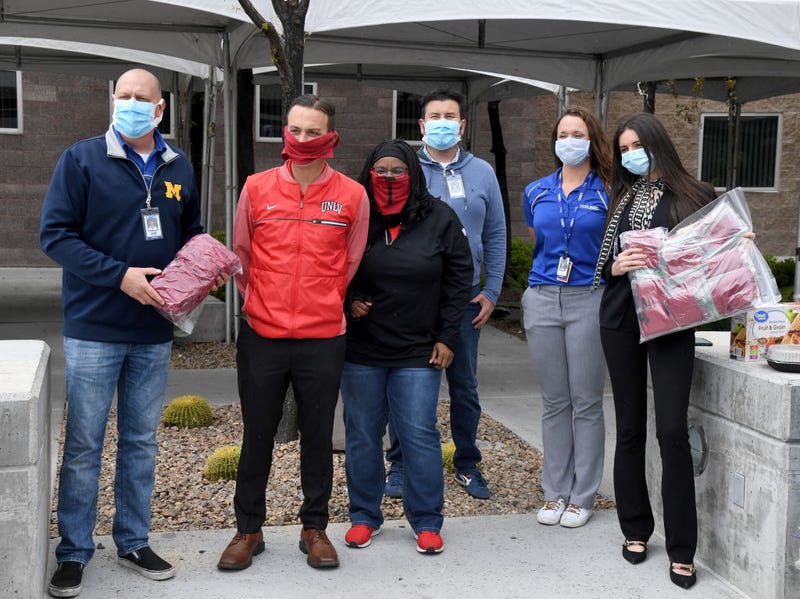Ronald Roemer from University Medical Center of Southern Nevada, UNLV Senior Associate Athletics Director for External Affairs John Gladchuk, UNLV Assistant Athletic Director, Equipment and Purchasing, Tausha Smith and Robert Bimbi, Kelly Cullerton and Marsha Al-Sayegh from UMC pose for photos after Gladchuk and Smith donated 1,500 cloth masks from UNLV Athletics to the hospital as the medical community continues to battle the coronavirus on April 10, 2020 in Las Vegas, Nevada. UNLV Athletics student-athletes, coaches, staff and their families are making a total of 3,000 masks made out of T-shirts supplied by Nike and the Andre Agassi Foundation for Education for the hospital. The World Health Organization declared the coronavirus (COVID-19) a global pandemic on March 11th.