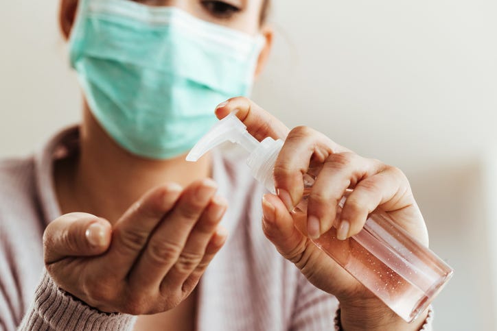A woman uses hand sanitizer