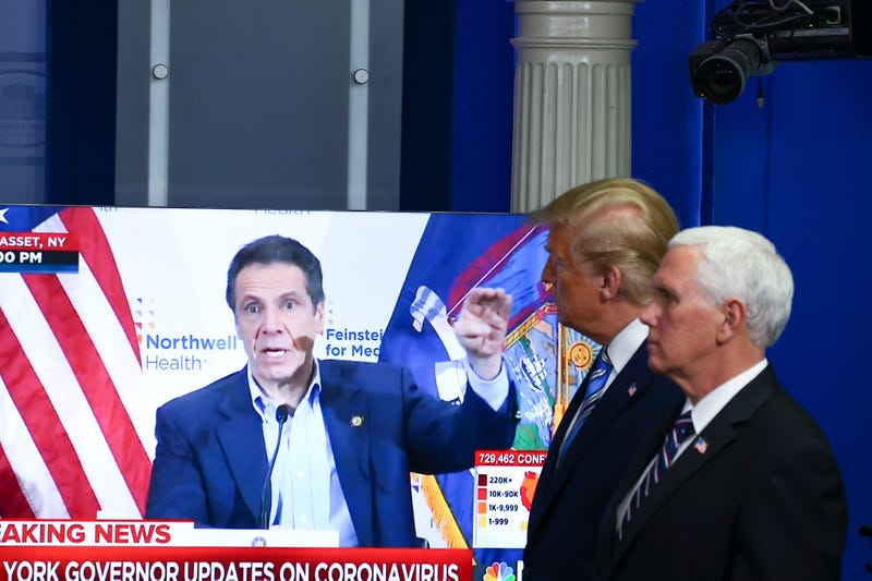 U.S. President Donald Trump and Vice President Mike Pence watch a TV clip of New York state Gov. Andrew Cuomo at the daily coronavirus briefing at the White House on April 19, 2020 in Washington, DC.