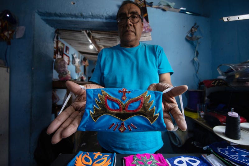 Former Mexican Lucha Libre wrestler, Isaac Huerta 'El Gato Gris', shows a 'Caristico' wrestler face mask on April 20, 2020 in Puebla, Mexico. Due to the COVID-19 pandemic, Huerta turned to produce themed protective masks in his own Lucha Libre masks studio, using the same materials.