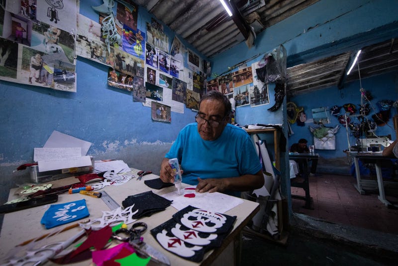 Former Mexican Lucha Libre wrestler, Isaac Huerta 'El Gato Gris', makes face masks of Mexican Lucha Libre wrestlers on April 20, 2020 in Puebla, Mexico. Due to the COVID-19 pandemic, Huerta turned to produce themed protective masks in his own Lucha Libre masks studio, using the same materials.