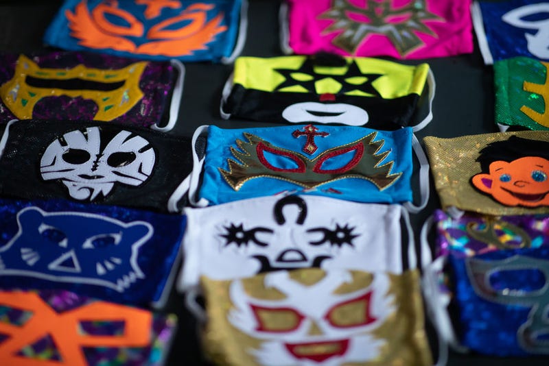 View of face masks from different Mexican Lucha Libre fighters on April 20, 2020 in Puebla, Mexico. Due to the COVID-19 pandemic, Huerta turned to produce themed protective masks in his own Lucha Libre masks studio, using the same materials.