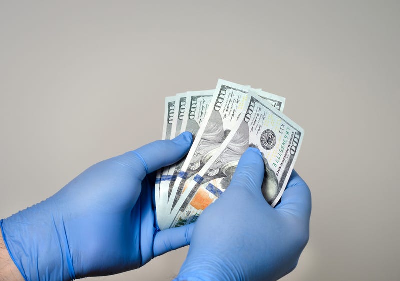 gloved hand counting american money