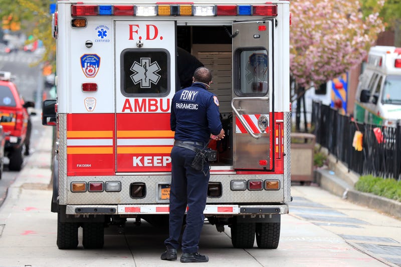 An FDNY paramedic unloads a patient from an ambulance near the Emergency Room entrance to the Brooklyn Hospital Center