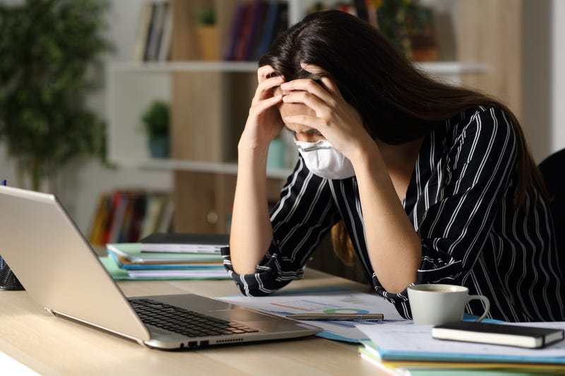 Sad teleworker woman wearing mask