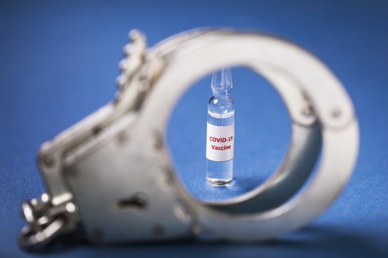 Coronavirus vaccine and handcuffs