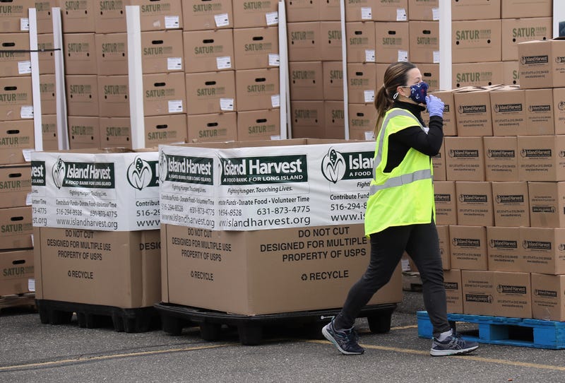 Workers at Island Harvest Food Bank working in conjunction with the Nourish New York initiative, distribute New York produced goods to people in need of food assistance on May 08, 2020 in Massapequa, New York