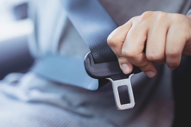 Man buckling seat belt.