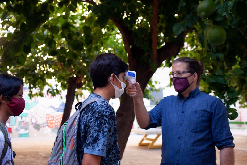 Mr. Ros, brother of the photographer, Teacher of Eso 1, takes the temperature of his students during the first day of school at Vedruna Angels School in Raval neighborhood on September 14, 2020 in Barcelona, Spain. As students begin to return to school after a six-month shutdown, Spain became the first country in western Europe to reach half a million confirmed COVID-19 infections.