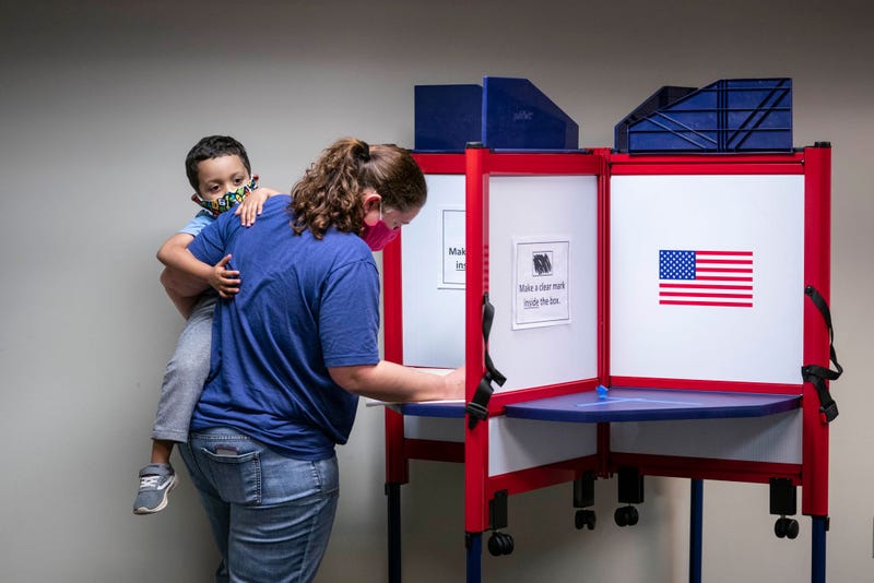 A woman casts her ballot for the 2020 presidential election at an early voting location on October 1, 2020 in Alexandria, Virginia. Virginia's early voting program for the November 3 national election began September 18 and continues through October 31.
