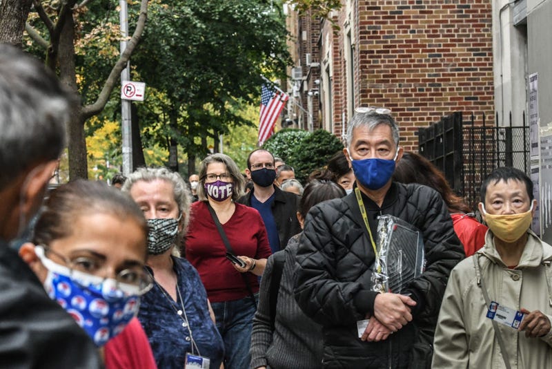 People wait in a line to vote at the Queens Public Library during early voting for the U.S. Presidential election on October 24, 2020 in the Jackson Heights neighborhood in the Queens borough in New York City. Due to the coronavirus and social distancing concerns New York State is allowing early voting for the first time.