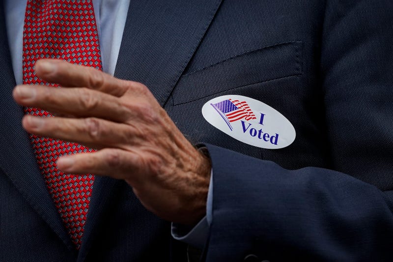 Democratic presidential nominee Joe Biden wears an "I Voted" sticker as he speaks to reporters outside the Delaware State Building after casting his ballot for the general election on October 28, 2020 in Wilmington, Delaware.