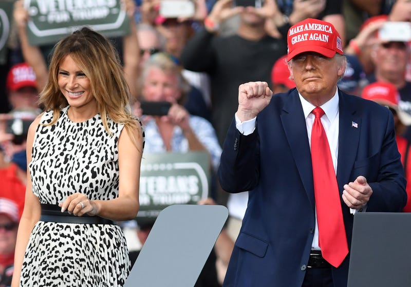 U.S. President Donald Trump and first lady Melania Trump gesture to supporters as they prepare to leave the stage at the conclusion of a campaign rally outside Raymond James Stadium on October 29, 2020 in Tampa, Florida.