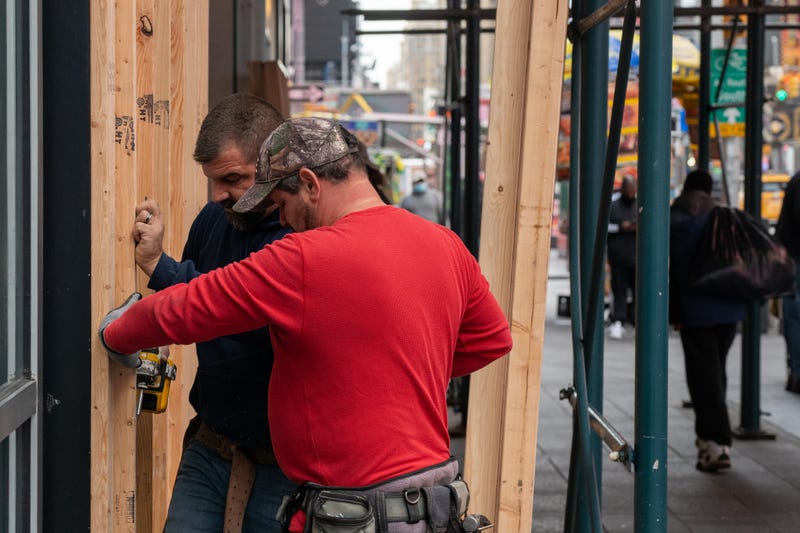 Carpenters board up a Forever 21 store in Times Square on November 1, 2020 in New York City.