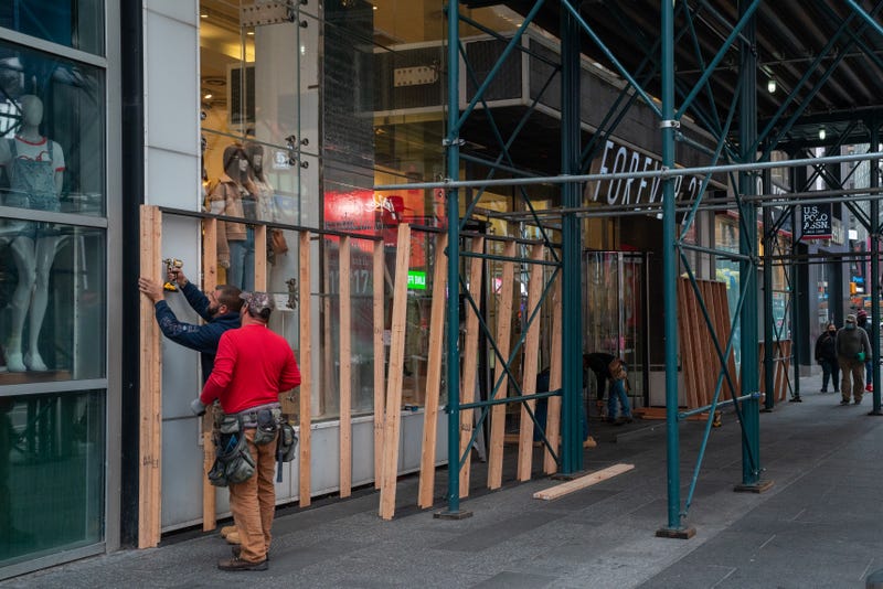 Carpenters board up a Forever 21 store in Times Square on November 1, 2020 in New York City.