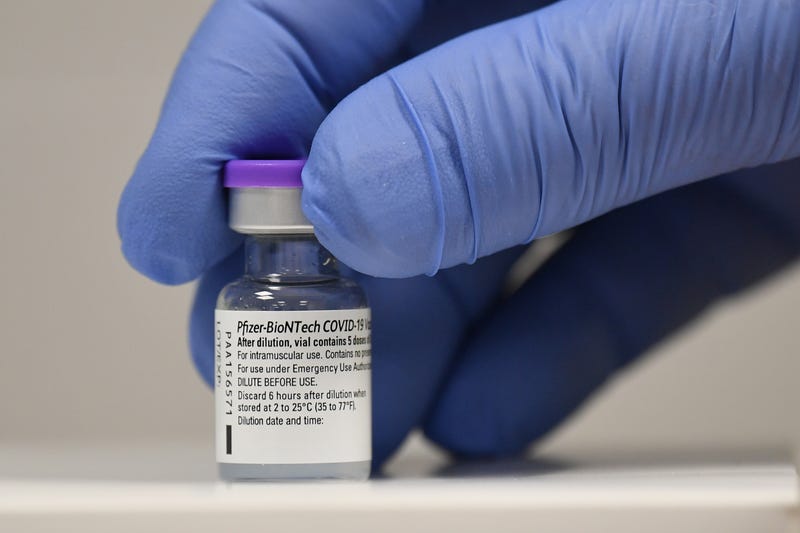 A member of staff poses with a phial of Pfizer-BioNTech Covid-19 vaccine at a vaccination health centre on the first day of the largest immunisation programme in the UK's history on December 8, 2020 in Cardiff, United Kingdom.