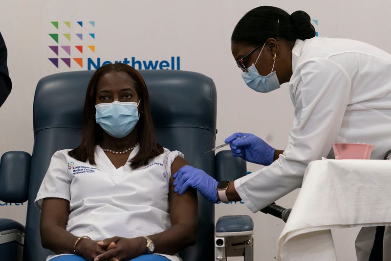 Sandra Lindsay, left, a nurse at Long Island Jewish Medical Center, is inoculated with the COVID-19 vaccine by Dr. Michelle Chester, on Dec. 14, 2020, in Queens