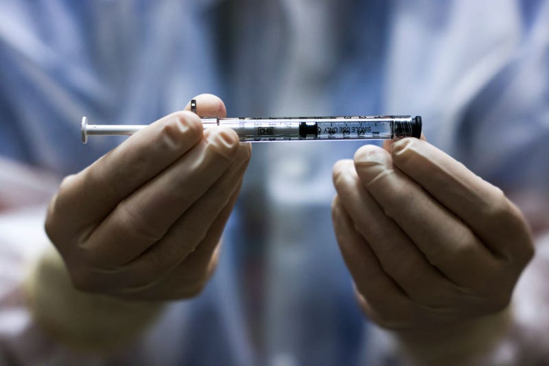 Rocky Mountain Regional VA Medical Center investigational pharmacy technician Sara Berech holds a dose of the Johnson & Johnson COVID-19 vaccine before it is administered in a clinical trial on December 15, 2020 in Aurora, Colorado.