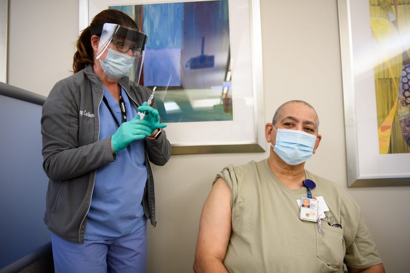 Nurse Mary Catherine Klee injects a COVID-19 vaccine dose into Housekeeper Mecrecco Pogue, 68, at the Pittsburgh VA Medical Center on December 17, 2020 in Pittsburgh, Pennsylvania