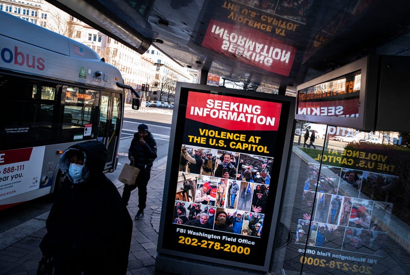 A billboard on a bus stop on Pennsylvania Avenue Northwest advertises a message from the Federal Bureau of Investigation seeking information related to violence at the U.S. Capitol, on January 9, 2021 in Washington, DC. A pro-Trump mob stormed and desecrated the U.S. Capitol on January 6 as Congress held a joint session to ratify President-elect Joe Biden's 306-232 Electoral College win over President Donald Trump.