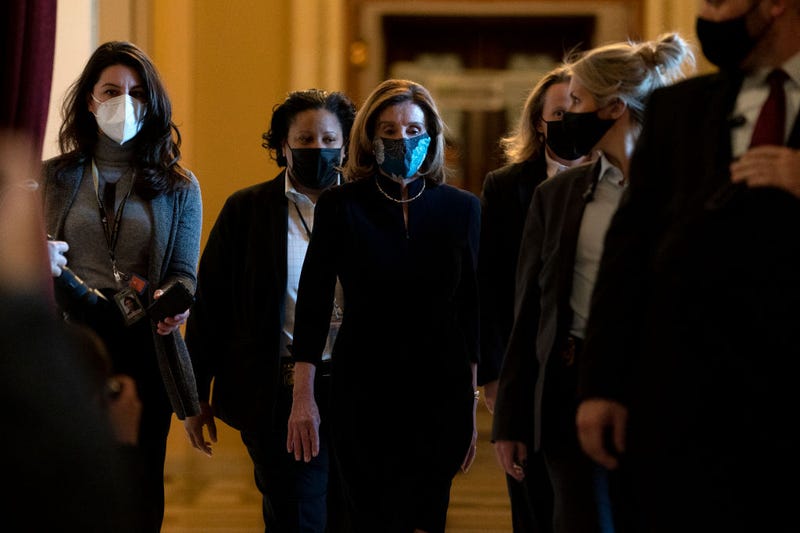 Speaker of the House Nancy Pelosi (D-CA) (C), surrounded by a security detail, walks to her office from the House Floor at the U.S. Capitol on January 13, 2021, in Washington, D.C.