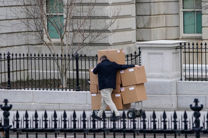 A man pushes a large cart full of boxes along West Executive Avenue between the West Wing of the White House and the Eisenhower Executive Office Building on January 15, 2021 in Washington, DC. According to recent news reports, President Donald Trump is slated to leave Washington the morning of Jan. 20th, hours before President-elect Joe Biden will be sworn-in as president.