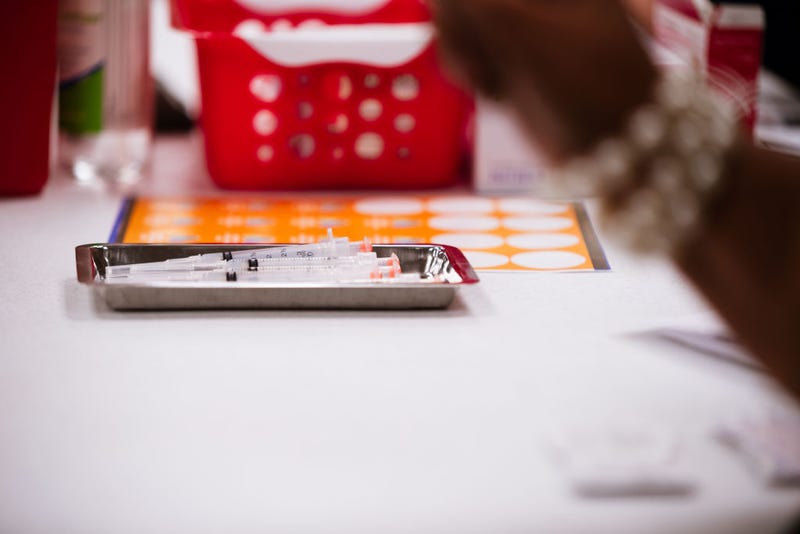 A medical tray full of syringes containing the Moderna COVID-19 vaccine is seen on a table