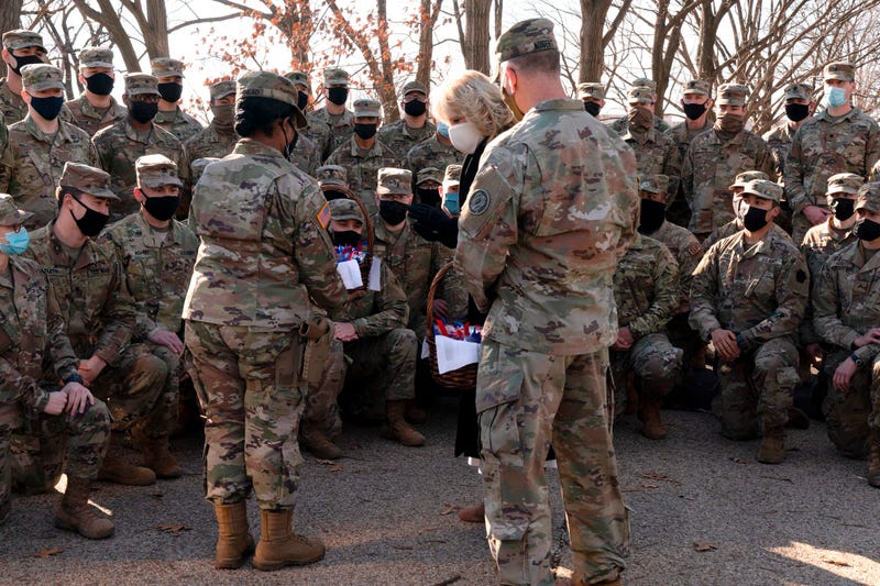 First lady Jill Biden talks with members of the National Guard, after surprising them with chocolate chip cookies and posing for photos outside the Capitol on January 22, 2021, in Washington, DC. 