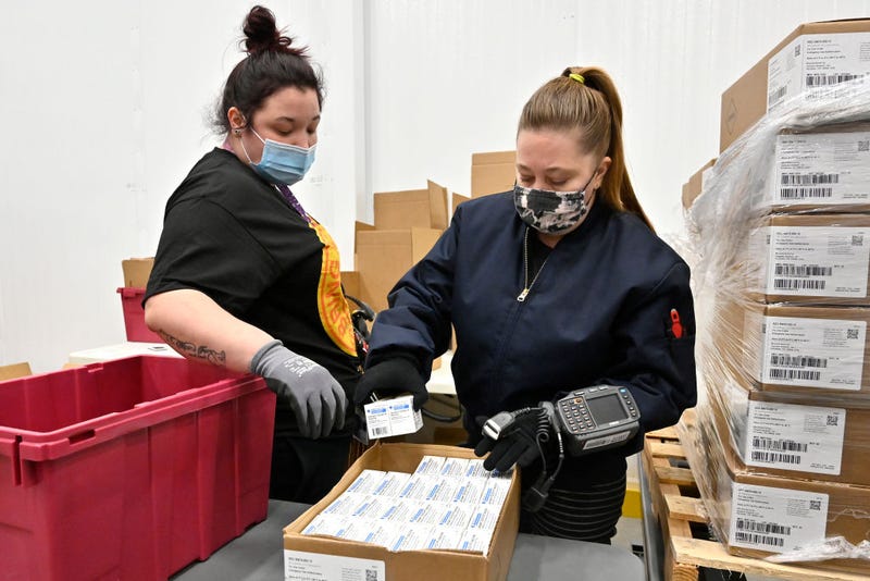 An employee with the McKesson Corporation scans a box of the Johnson and Johnson COVID vaccine as she fills an order at their shipping facility on March 1, 2021 in Shepherdsville, Kentucky. The FDA has approved a third vaccine and 3.9 million doses of J&J will begin distribution.