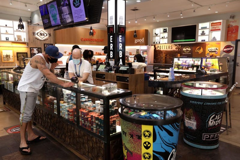An employee of Erba Markets helps a customer at the cannabis store in Los Angeles.