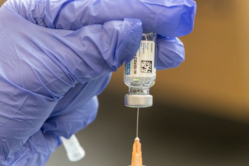A healthcare worker loads a syringe with the Johnson & Johnson Covid-19 vaccine.