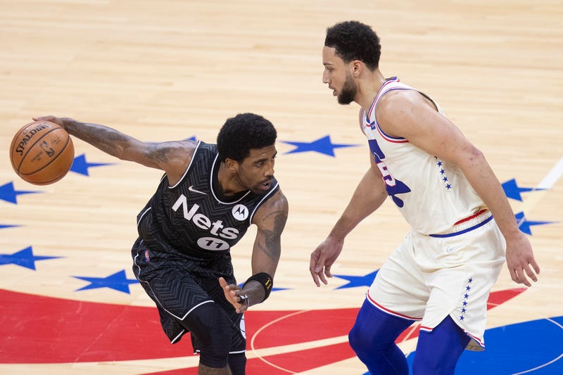 Nets star Kyrie Irving guarded by Sixers' Ben Simmons.