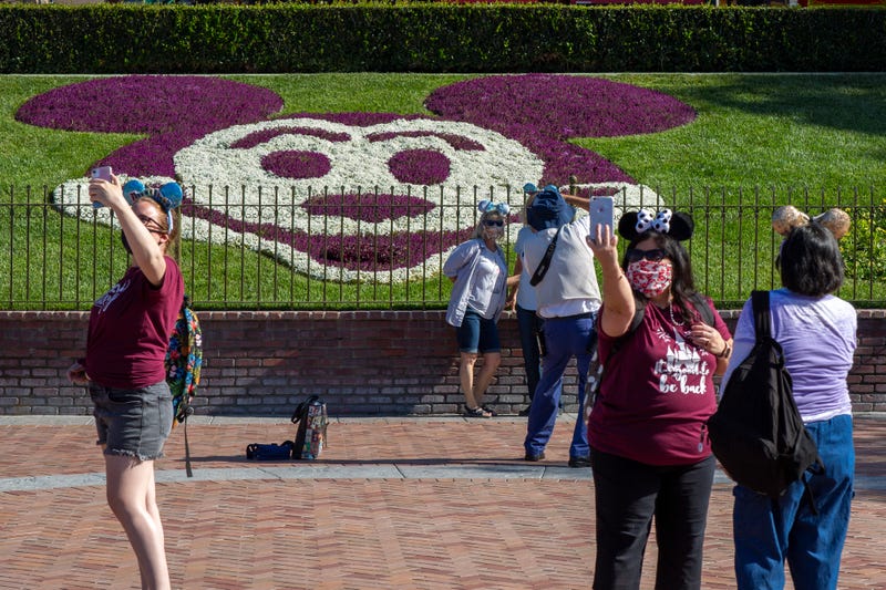 People enter Disneyland Park as it reopens for the first time since the COVID 19 pandemic forced the park to shut down last year on April 30, 2021 in Anaheim, California.