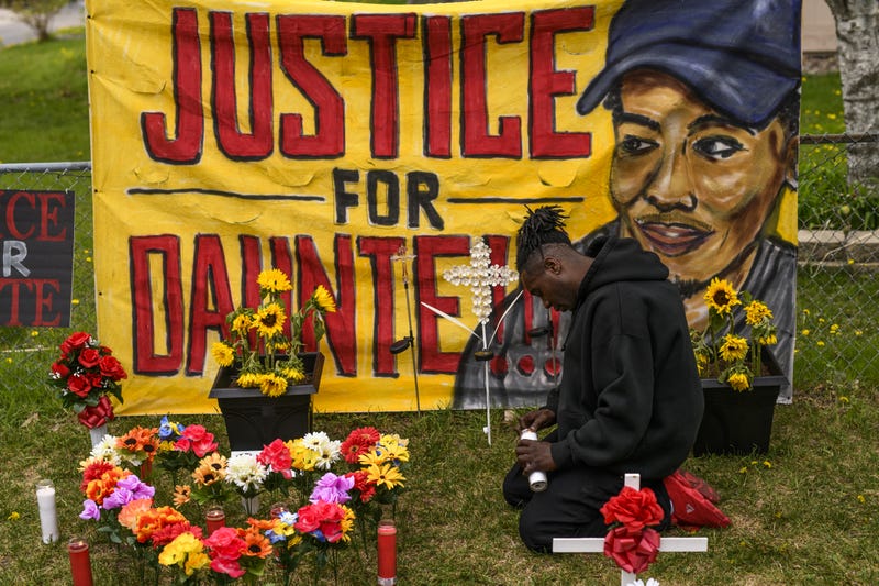 Antwon Davis lights candles at a memorial for Daunte Wright on May 2, 2021 in Brooklyn Center, Minnesota.