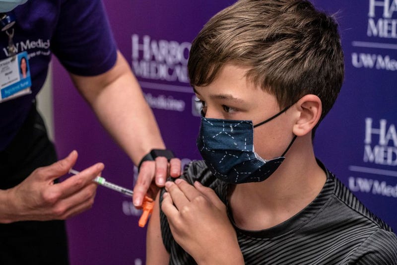Gavin Smits, 12, receives a first dose of the Pfizer COVID-19 vaccine at Harborview Medical Center on May 13, 2021 in Seattle, Washington