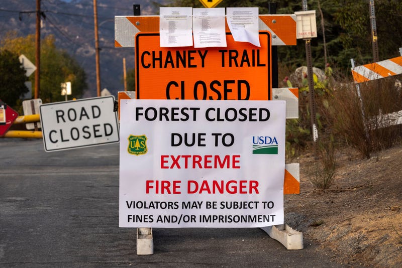 A closure sign is seen as the Angeles National Forest, along with all national forests in California, is closed due to dangerous wildfire conditions on Sept. 1, 2021 in Altadena, California. California and the West are experiencing unprecedented large and destructive wildfires along with record drought as worsening climate change creates extreme weather conditions across the continent, according to climate scientists. California's national forests will remain closed through at least Sept. 17, just as the season for hot, powerful Santa Ana winds in Southern California typically begins, bringing in the most dangerous wildfire weather of the year through early December.