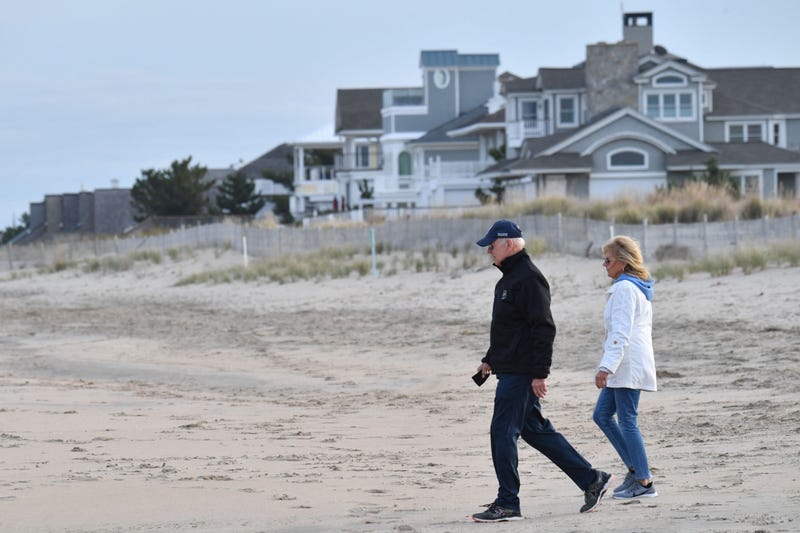 US President Joe Biden and First Lady Jill Biden walk on the beach at Cape Henlopen State Park in Lewes, Delaware on November 7, 2021.