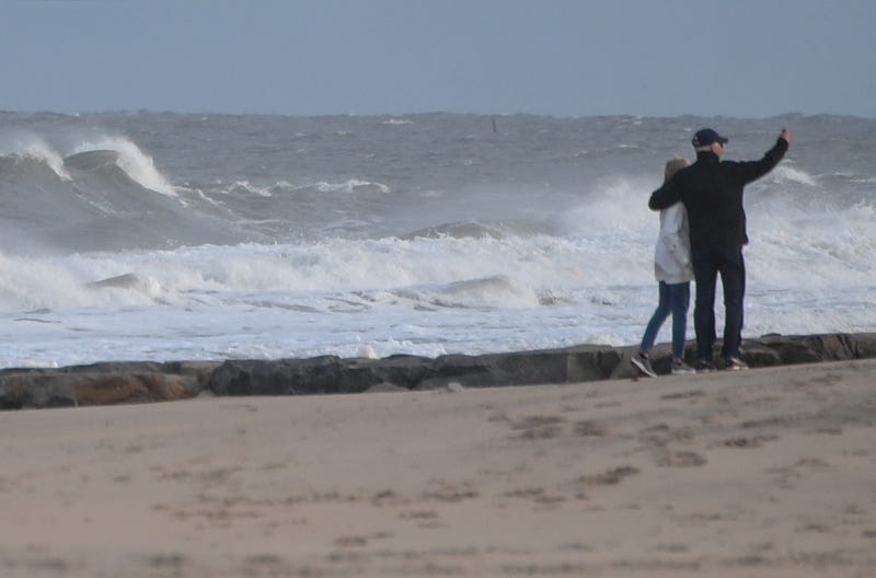 US President Joe Biden and First Lady Jill Biden walk on the beach at Cape Henlopen State Park in Lewes, Delaware on November 7, 2021.